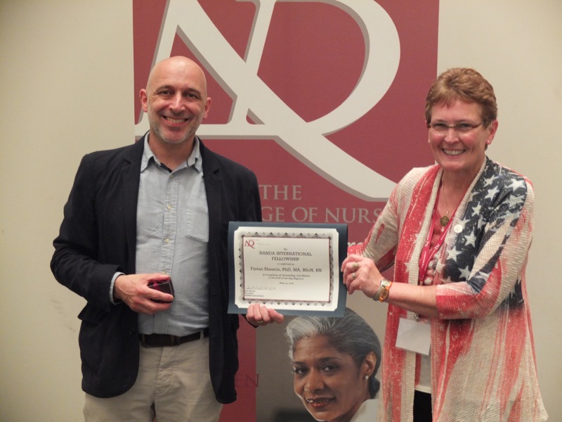 Dr Fintan Sheerin receiving the award from outgoing NANDA-I president, Dr Jane Brockel.