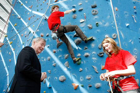 Minister seamus brennan is shown the ropes by tcd students jennifer kennedy and luke stratford at the college's climbing wall.